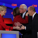 Democratic presidential candidates Sen. Elizabeth Warren (D-Mass.), left, greets former Maryland congressman John Delaney while Sen. Bernie Sanders (I-Vt.) hugs Sen. Amy Klobuchar (D-Minn.) after the Democratic Presidential Debate at the Fox Theatre July 30, 2019, in Detroit.